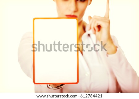 Young business woman holding a board with ban