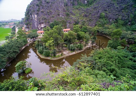 Hang Mua (Mua Cave) A trekking spot in Ninh Binh with impressive panoramic view of golden rice fields, limestone mountains along Ngo Dong river in Tam Coc