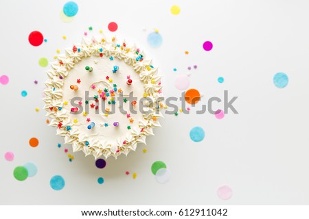 Birthday cake with colorful candles Royalty-Free Stock Photo #612911042