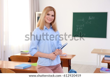 Portrait of beautiful female teacher in classroom