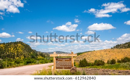 Cheyenne Wyoming travel sign with nature background at state border USA