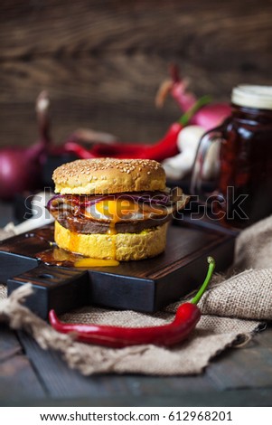 Homemade Burger on a black charred wooden serving board