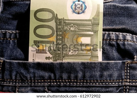 macro 100 euro banknote in jeans pocket 