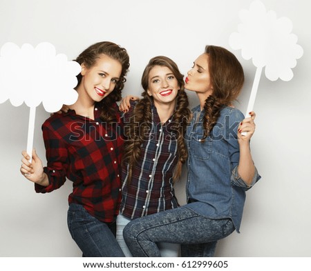 life style and people concept: stylish girls best friends holding blank paper on stick.