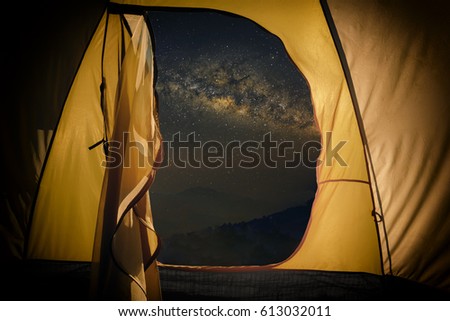 Inside camping tent at night against amazing sky full of stars and milk way