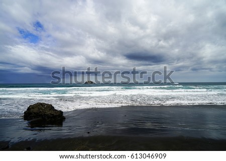 Sea rock surging waves.Dramatic dark cloudy sky over sea, natural photo background.