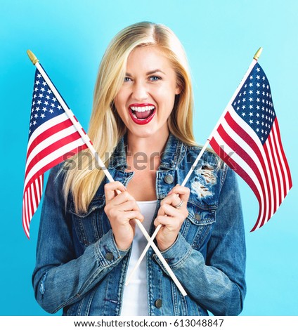 Happy young woman holding American flag