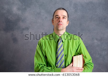 young lawyer in green shirt and necktie with statute book 