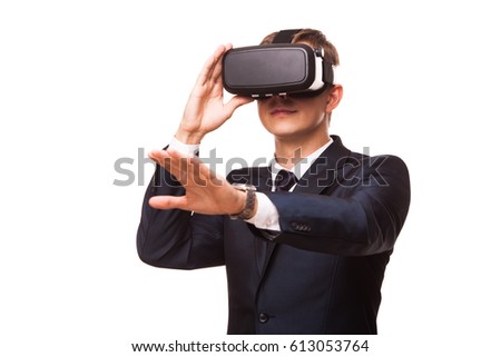 Young handsome businessman in black suit wearing virtual reality goggles., isolated on white background