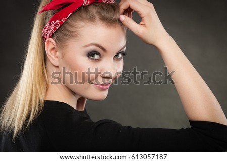 Retro and vintage style. Old fashion. Portrait of lovely pretty young woman in pin up hairstyle with red handkerchief on head.