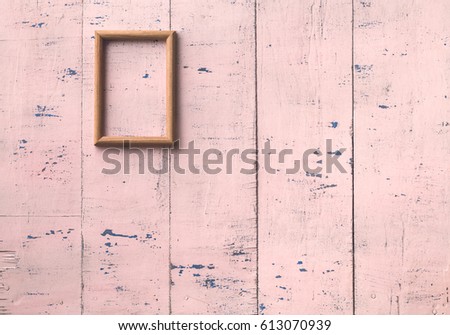vintage photo frame on old pink wooden wall