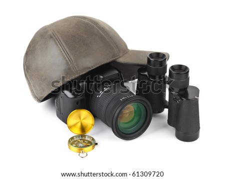 Photo camera, compass, binoculars and cap - travel concept