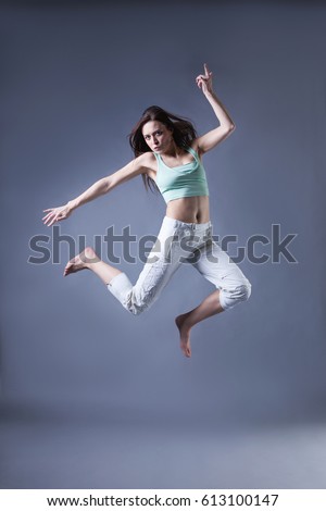 beauty girl dance on grey background. person jumping, flying in the air
