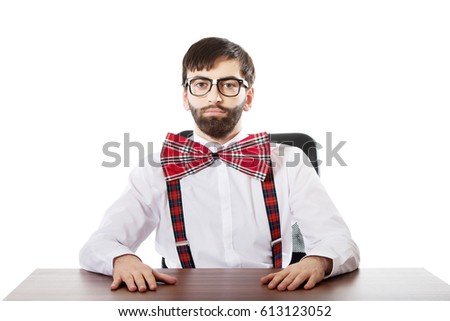 Young old fashioned man sitting by a desk.
