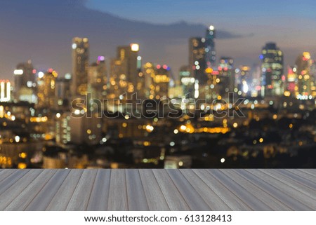 Opening wooden floor, City blurred bokeh light night view, abstract background