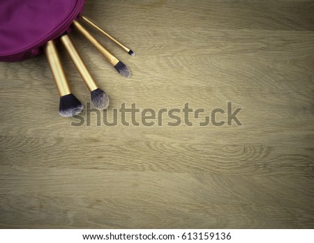 Make up brushes on wooden background. Top view.