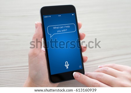 Women hands holding phone with app personal assistant on screen over table
 Royalty-Free Stock Photo #613160939