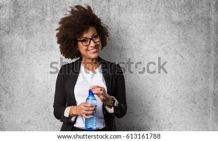 business black woman holding a bottle of water