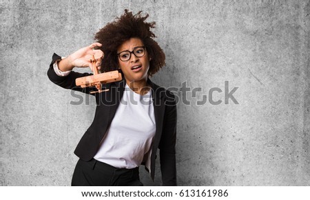 business black woman playing with a wooden plane