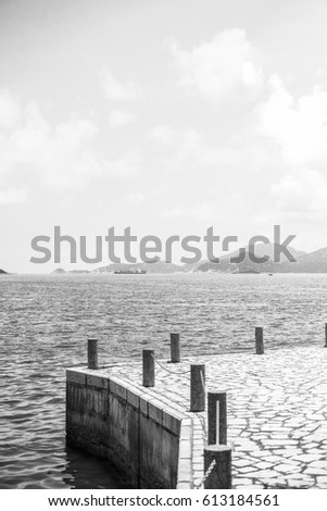 Lonely Harbour with the blue sky in black and white 