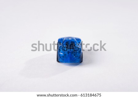 Toy plastic blue car on white background