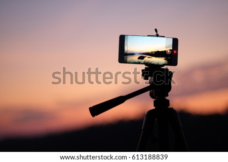 smart phone on tripod nuture view on screen at sunset