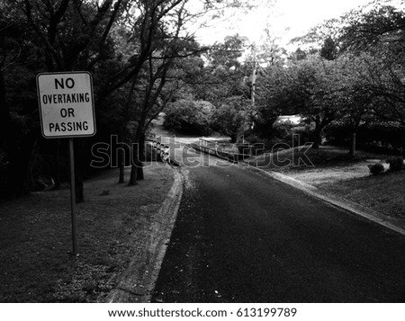 Black and white photo of a suburban street in Australia