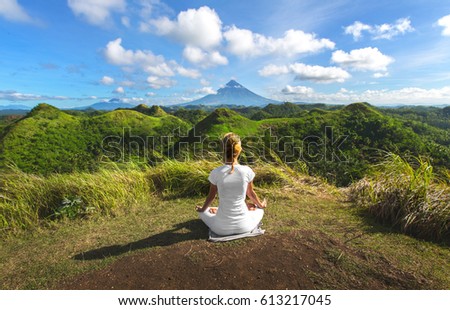 Serenity and yoga practicing,meditation at Quitinday hills location,Mayon volcano at background, Philippines