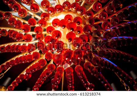 Red chandelier in the restaurant. Blurred decorated lights for elegant party. Background for a holiday card. celebration
