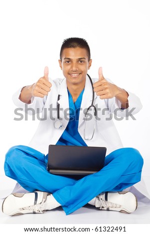 cheerful indian medical intern giving thumbs up