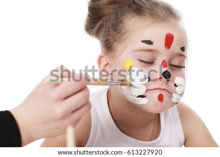 Happy beautiful little girl with painted face, isolated on white background