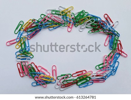 Stack of colorful paper clips on white background.