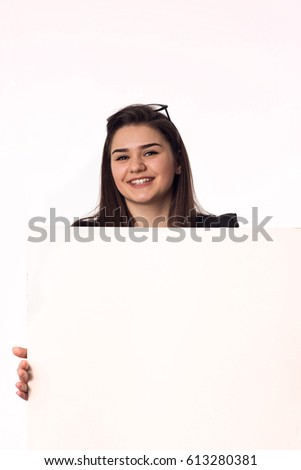 beautiful young woman with big empty poster on the white background