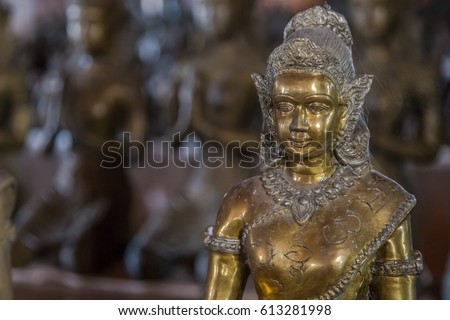 Thai Art, Thai Angel Antique Isolated, The Sculpture of holy women . A golden ancient Buddha statue in Museum