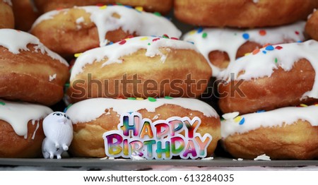 Colorful Happy Birthday sign on sweet donuts background