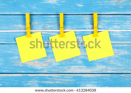 View of clothespins hanging on a rope with cards
