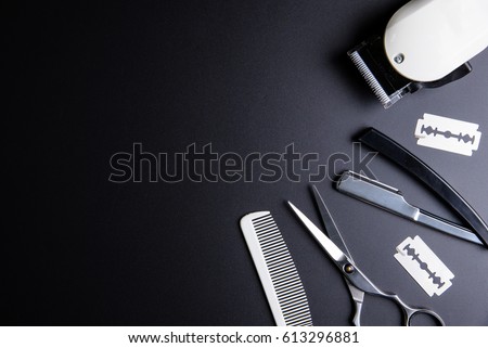 Razor, Stylish Professional Barber Scissors, White comb and White electric clippers on black background. Hairdresser salon concept, Hairdressing Set. Haircut accessories. Copy space image, flat lay Royalty-Free Stock Photo #613296881
