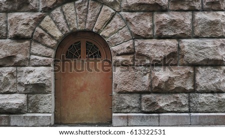 Metal door on the granite stone wall.