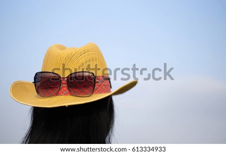 Summer vacation. Straw hat with sunglasses on hair a beautiful girl. Hat and sunglasses on vintage sky background. pastel tone