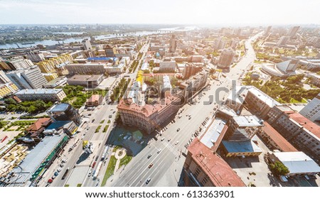 Aerial city view with crossroads, roads, houses, buildings, parks and parking lots. Copter drone helicopter shot. Panoramic wide angle image.