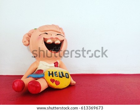 Hello Smiling and laughing clay doll, Welcome concept.