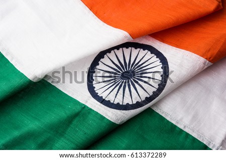 Closeup picture of indian flag made up of pure cotton or khadi, showing texture and folds, selective focus