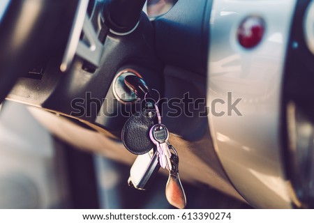 The car keys in the ignition lock. Warm toned picture, vintage tone.