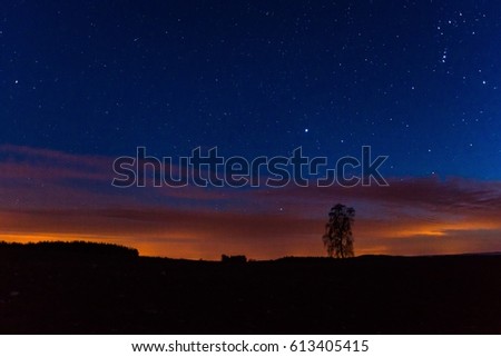 Night sky over rural landscape. Beautiful night starry sky, high ISO landscape. 