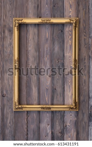 Baroque, gold, old, victorian, empty frame on a wooden wall