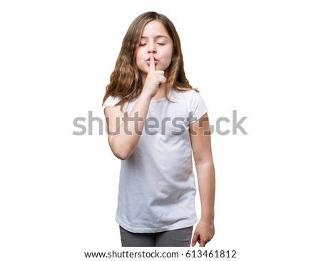 little girl doing silence gesture