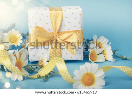 Bouquet of daises and gift box. 