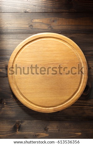 pizza cutting board at brown background texture