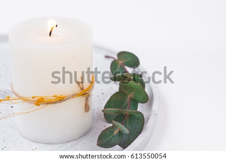 White candle on grey tray, eucalyptus branch, styled stock image for product and social media marketing, copyspace