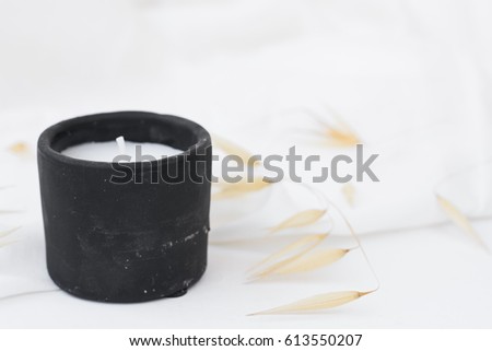 Black stone candle, dry plants, wild oats on white background, styled stock image for social media, marketing, blogging